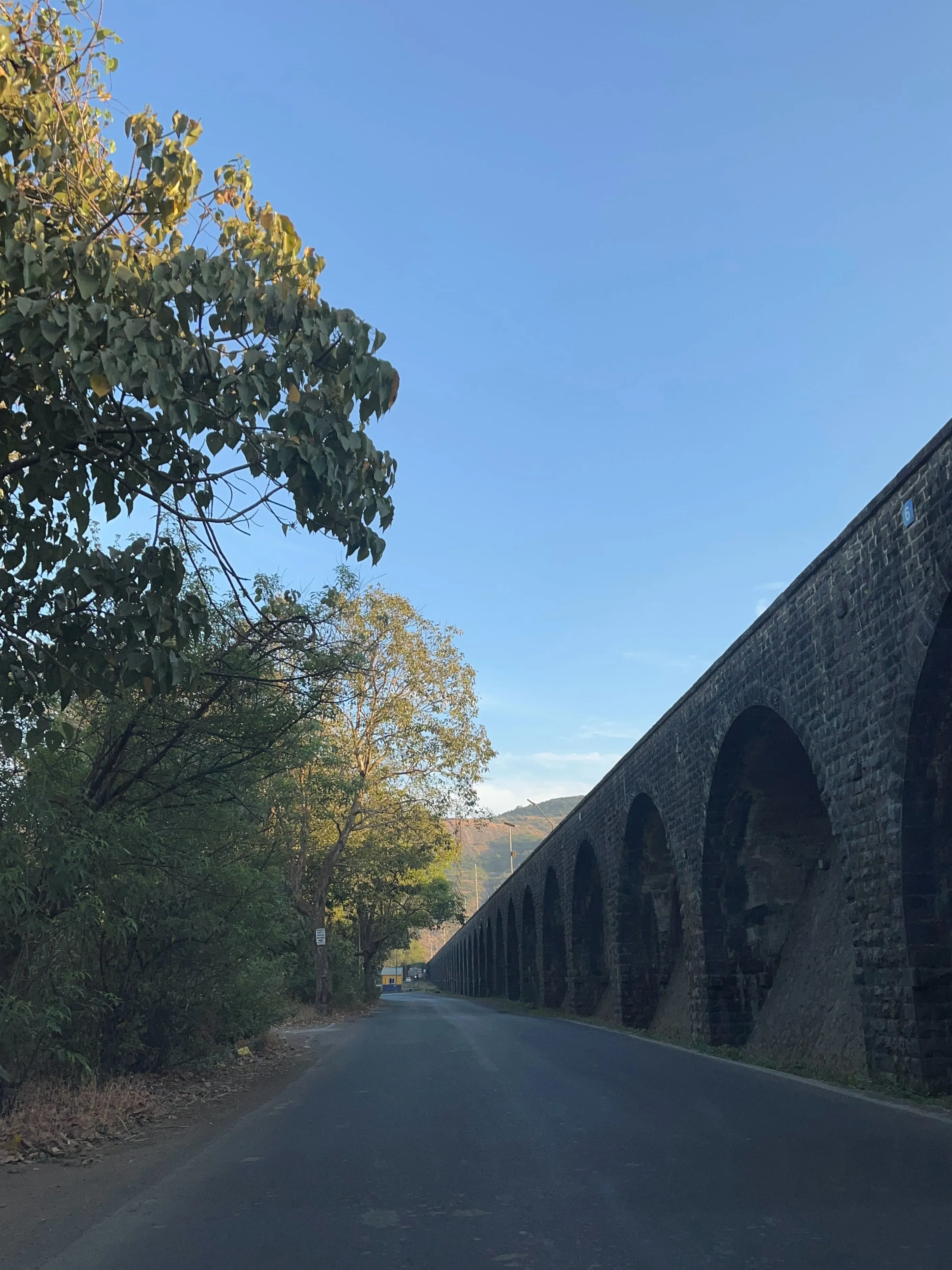 A road beside an old stone aqueduct